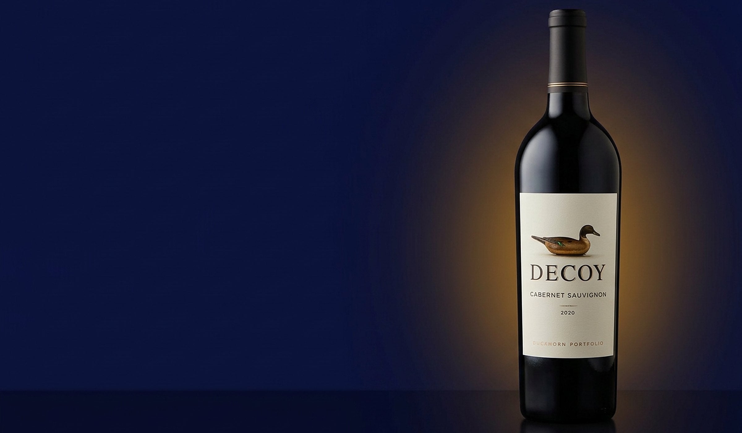 Decoy Cabernet Sauvignon 750 mL bottle from the Duckhorn Portfolio on a navy background